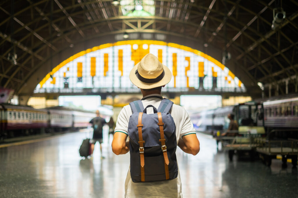 young-man-traveler-with-backpack-waiting-train